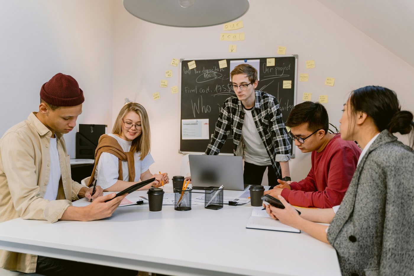 A small team planning a project together at a whiteboard