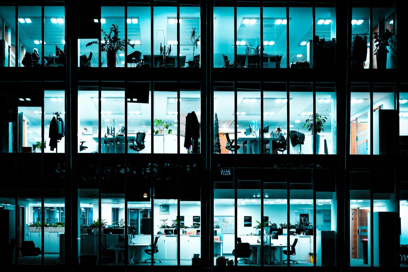 An office building lit up with people working at night