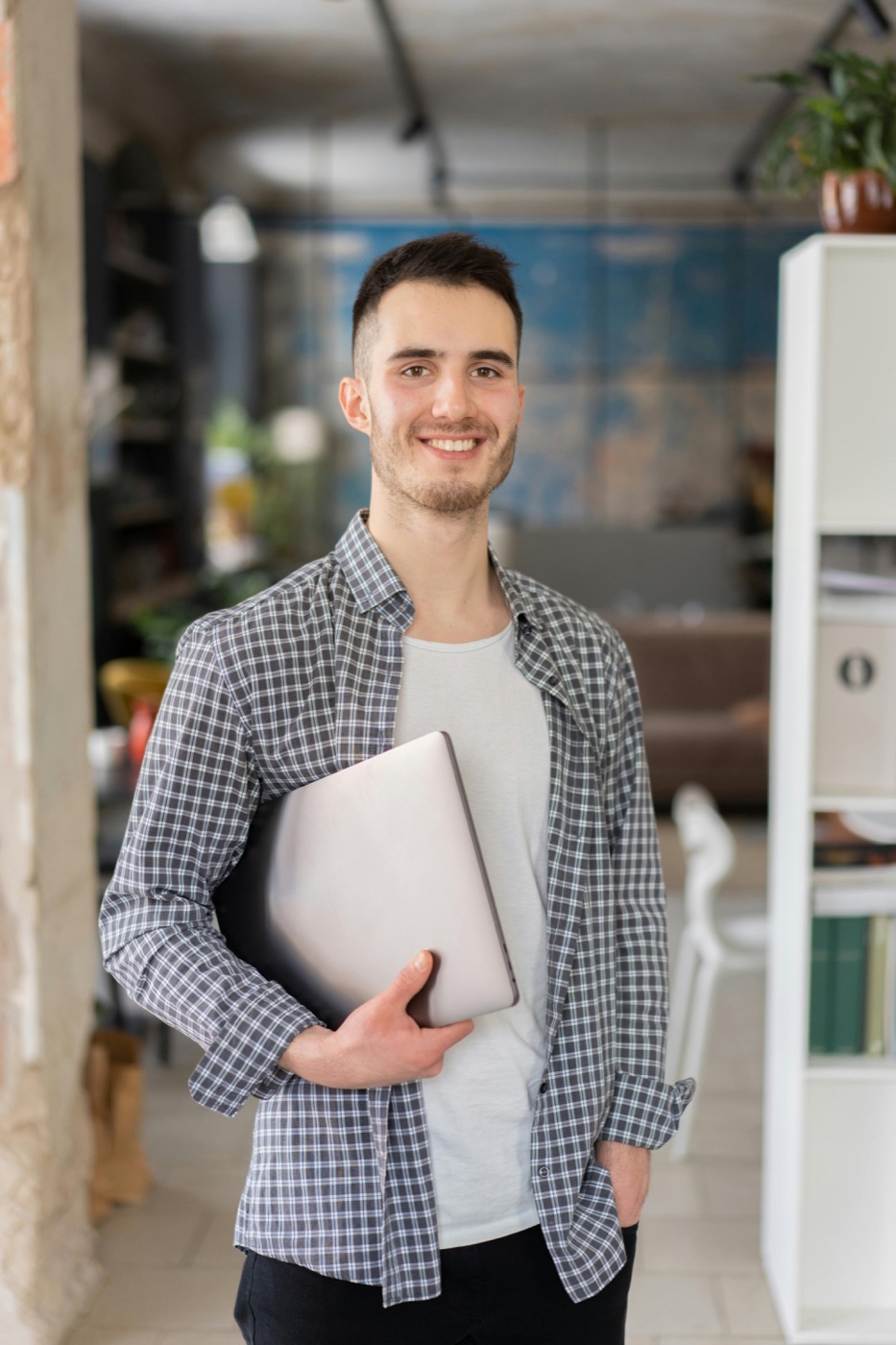 A freelancer holding a laptop, ready to get started
