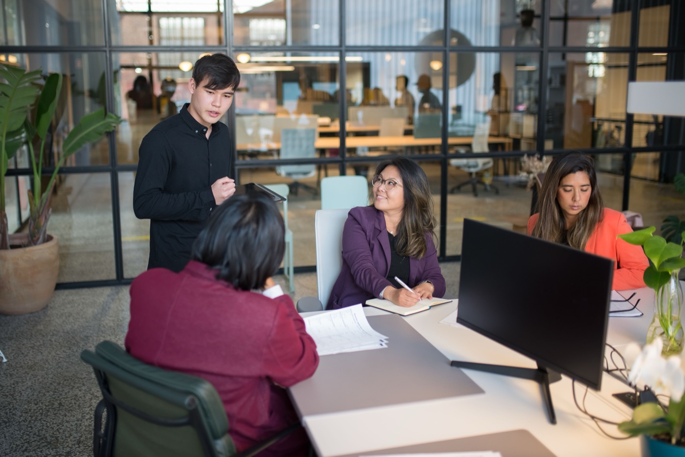 A team collaborating around a desk in a modern office