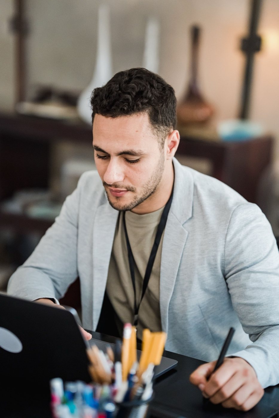 A freelancer focused on work at a creative desk with a laptop