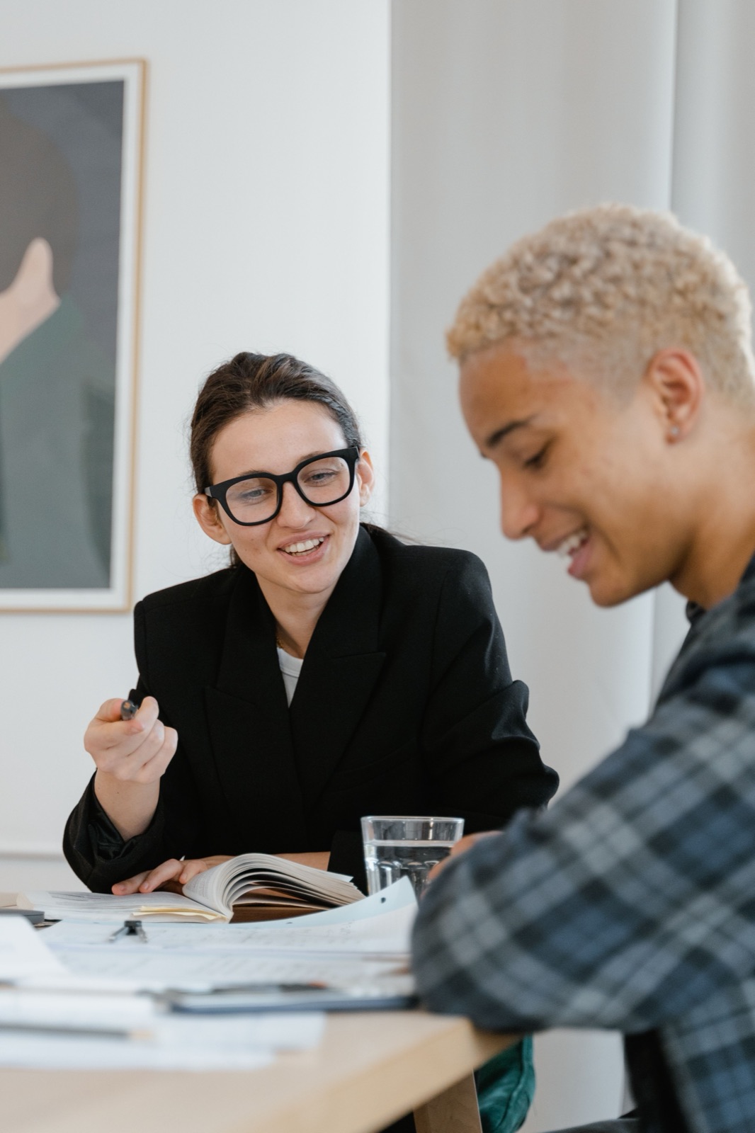 A client and a freelancer reviewing a project together at a desk