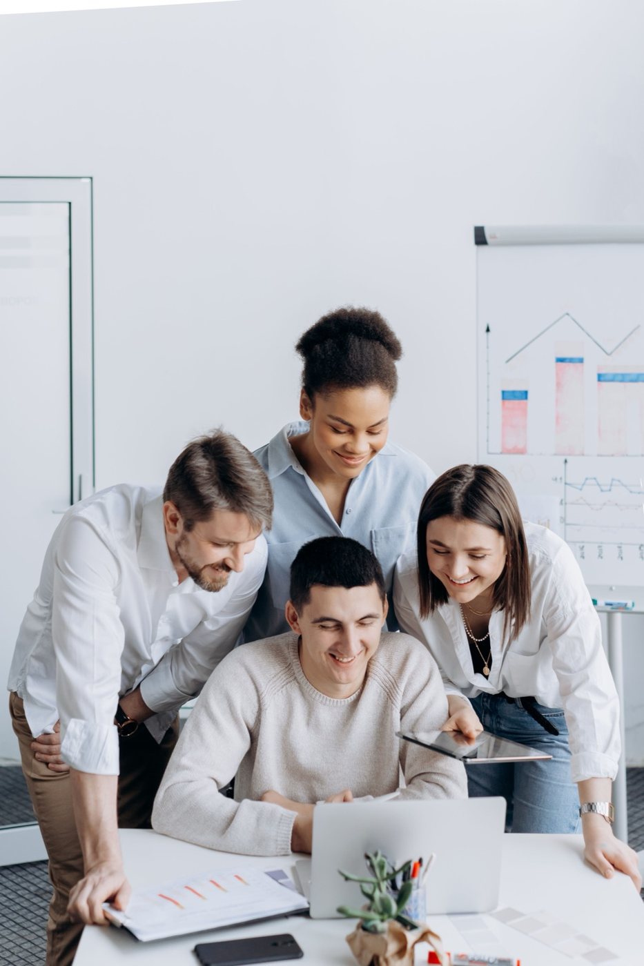 A team reviewing project results together on a laptop